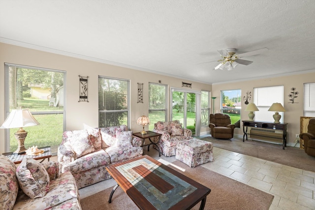 living room with ceiling fan, ornamental molding, and a textured ceiling