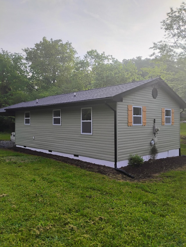 back of house with a lawn, a shingled roof, and crawl space