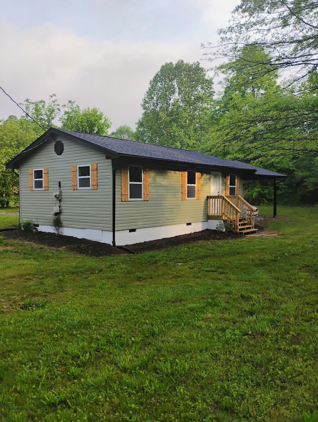 back of property with a yard and crawl space