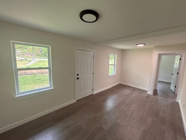interior space with baseboards and dark wood-style floors