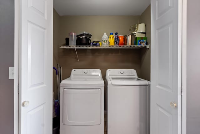 laundry area featuring washing machine and clothes dryer and laundry area