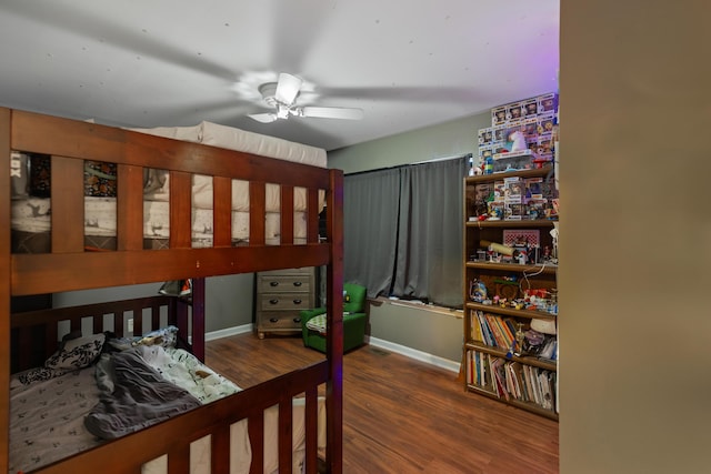 bedroom with baseboards, wood finished floors, and ceiling fan