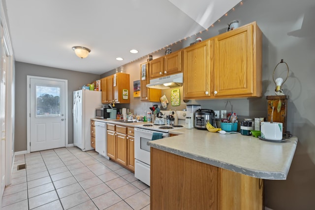 kitchen with light countertops, a peninsula, white appliances, under cabinet range hood, and light tile patterned floors