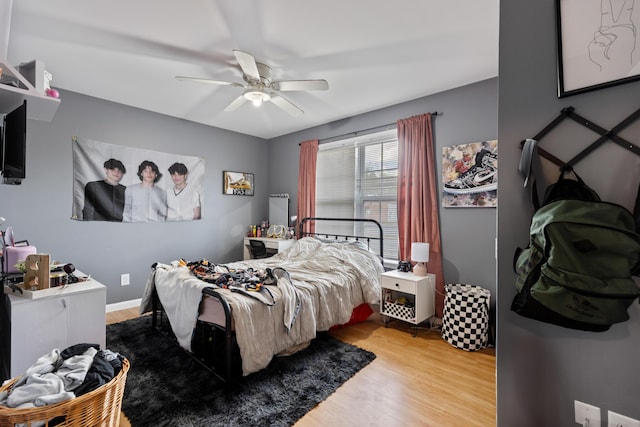 bedroom featuring wood finished floors and ceiling fan