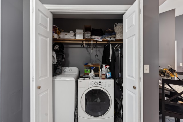 washroom featuring laundry area and separate washer and dryer