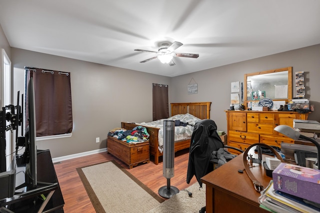 bedroom featuring baseboards, ceiling fan, and wood finished floors