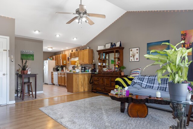 living room with high vaulted ceiling, light wood finished floors, baseboards, ceiling fan, and recessed lighting