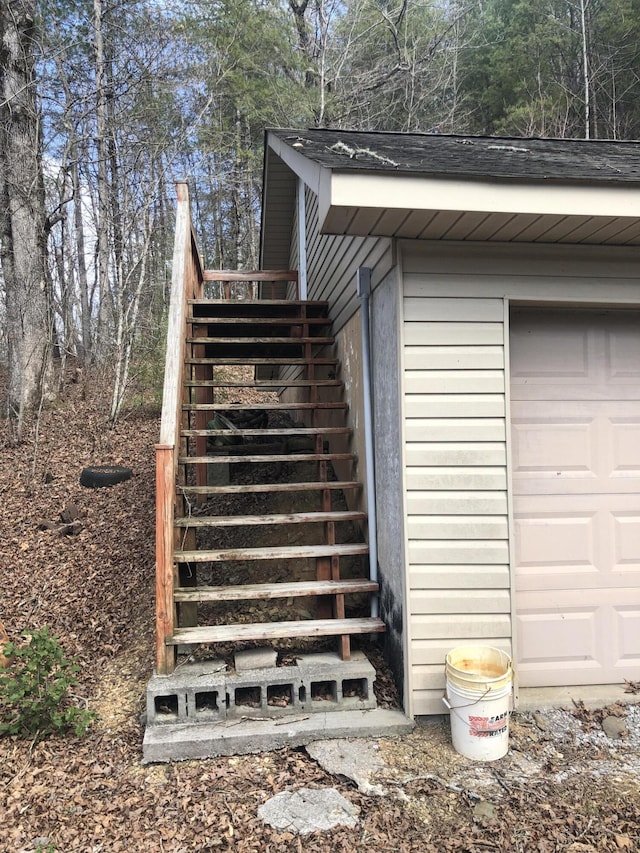 view of side of property featuring stairs