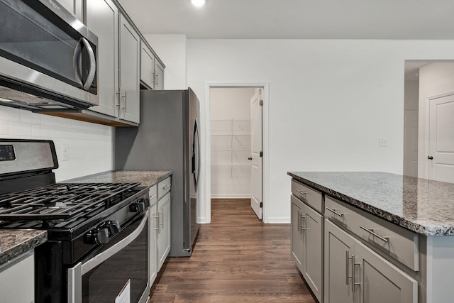 6026 Pearson Ln NW Unit 31, Cleveland, TN 37312 - kitchen with stainless steel appliances, gray cabinetry, dark wood-style flooring, dark stone counters, and backsplash