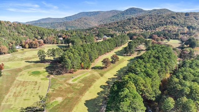 aerial view with a view of trees, a mountain view, and golf course view