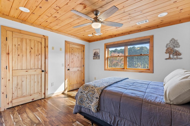 bedroom with baseboards, visible vents, ceiling fan, wood ceiling, and wood finished floors