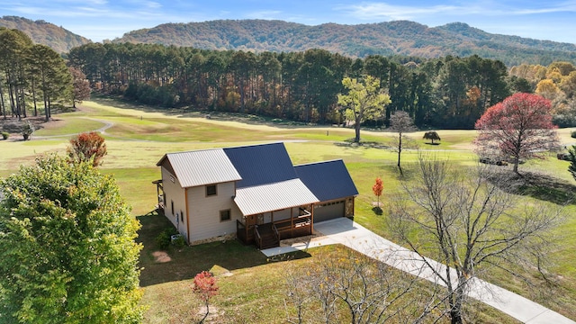 birds eye view of property with a wooded view and a mountain view