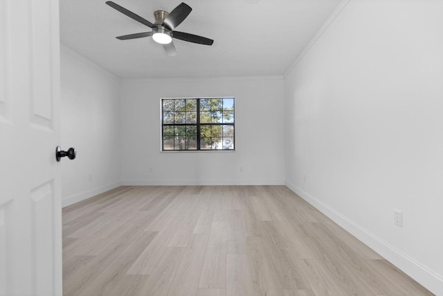 empty room with baseboards, a ceiling fan, light wood-style floors, and crown molding