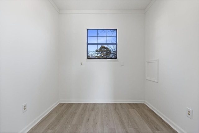 empty room featuring baseboards and light wood-style flooring