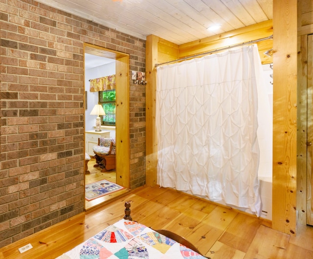 179 County Road 484, Englewood, TN 37329 - bedroom featuring hardwood / wood-style flooring, brick wall, and wood ceiling