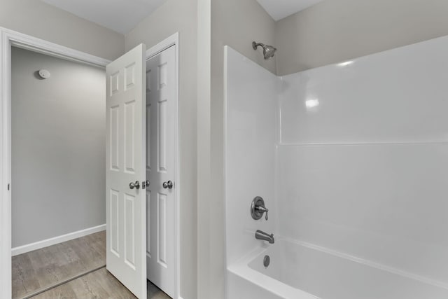 bathroom with shower / bathtub combination and wood-type flooring