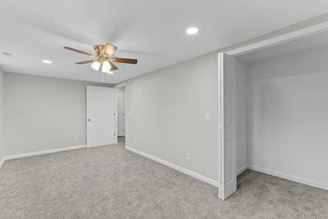 carpeted spare room featuring ceiling fan