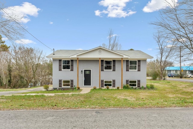 split foyer home with a front lawn