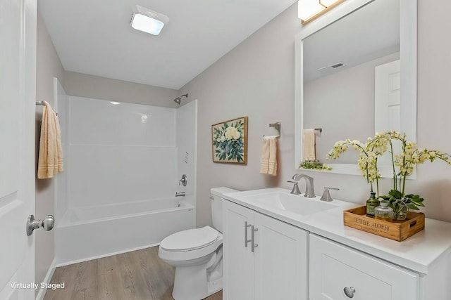 full bathroom featuring toilet, vanity, shower / bathtub combination, and hardwood / wood-style flooring