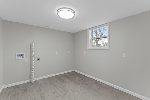 empty room with light hardwood / wood-style flooring