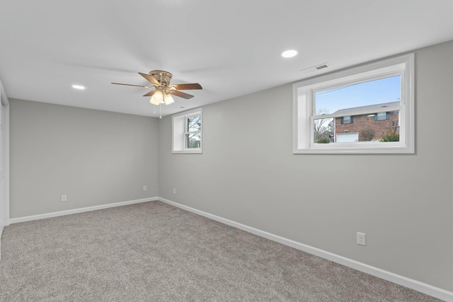 empty room with ceiling fan and carpet floors