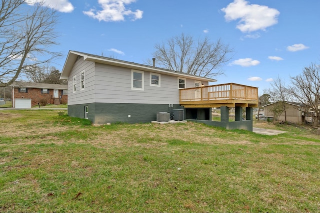 back of house with central air condition unit, a wooden deck, and a yard