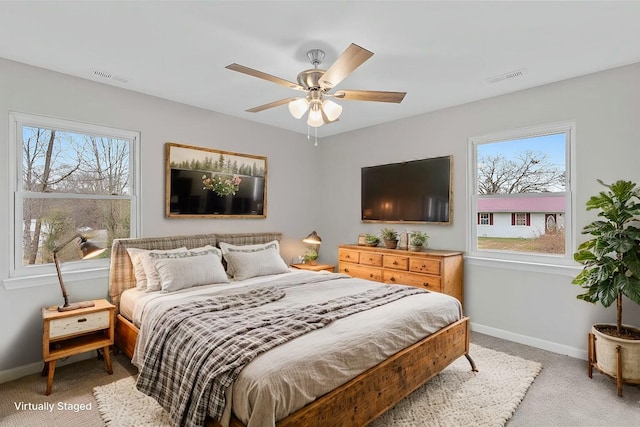 bedroom featuring multiple windows, ceiling fan, and carpet floors