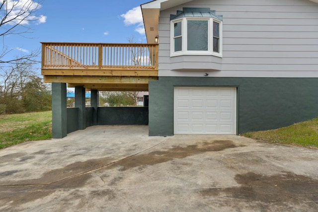 view of side of property with a garage and a deck