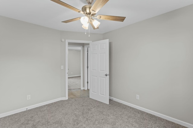 spare room featuring ceiling fan and light carpet