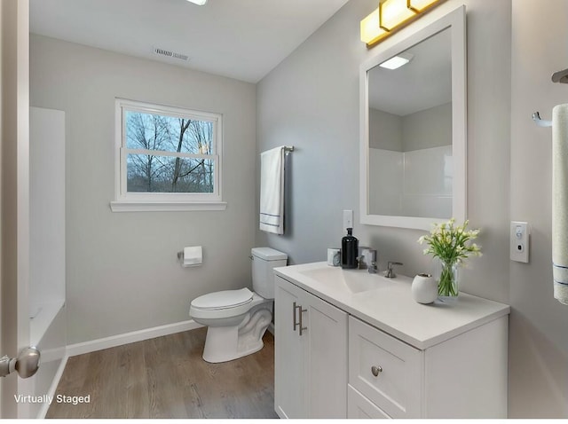 bathroom featuring hardwood / wood-style floors, vanity, and toilet