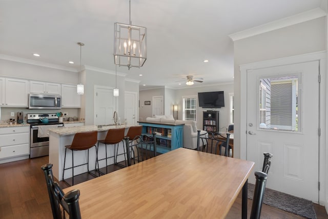 131 Winesap Way SW, Cleveland, TN 37311 - dining area featuring recessed lighting, crown molding, dark wood-type flooring, a ceiling fan, and a chandelier