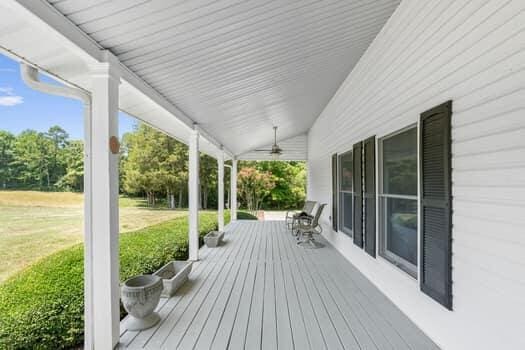 deck featuring a lawn and ceiling fan