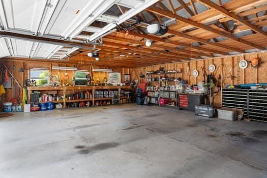 garage featuring a workshop area and a garage door opener