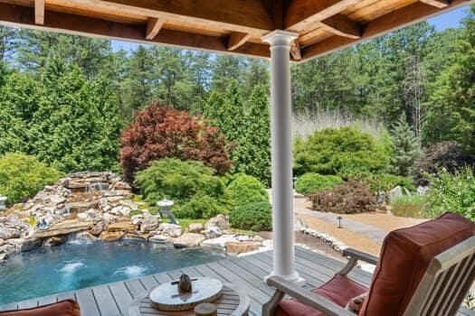 wooden deck featuring a hot tub