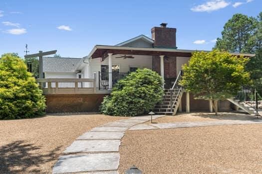 view of front of home with ceiling fan and a deck