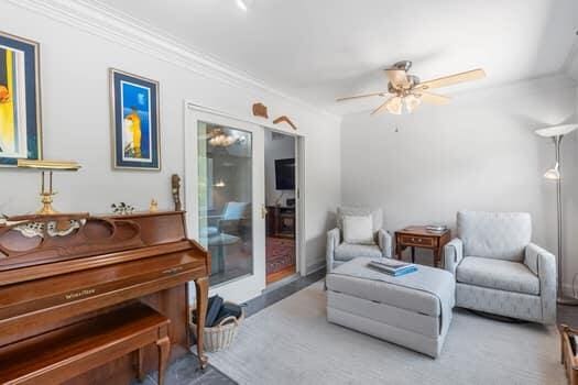 sitting room with ceiling fan and crown molding