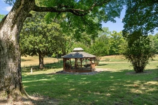 surrounding community featuring a gazebo and a lawn