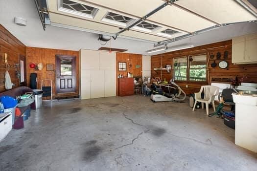 garage featuring wood walls