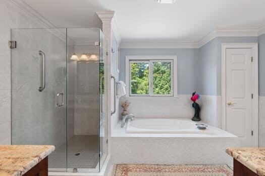 bathroom with shower with separate bathtub, vanity, and ornamental molding