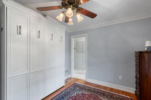 interior space with ceiling fan, a closet, ornamental molding, and light hardwood / wood-style flooring