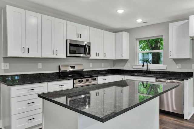 810 Cedar Springs Rd, Athens, TN 37303 - kitchen with stainless steel appliances, dark stone countertops, recessed lighting, white cabinetry, and a kitchen island