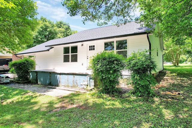 810 Cedar Springs Rd, Athens, TN 37303 - rear view of house with a shingled roof and a lawn