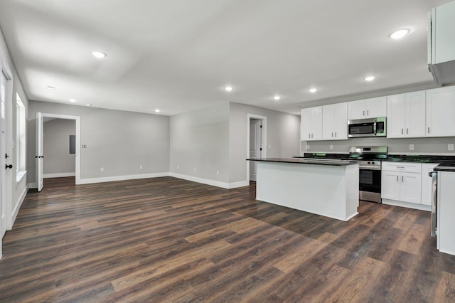 810 Cedar Springs Rd, Athens, TN 37303 - kitchen featuring appliances with stainless steel finishes, dark countertops, dark wood finished floors, a center island, and baseboards