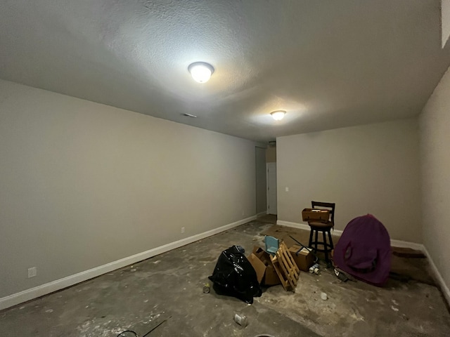 interior space with baseboards and a textured ceiling