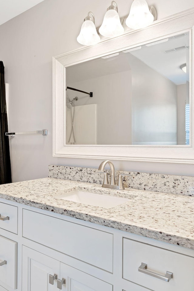 bathroom featuring vanity and walk in shower