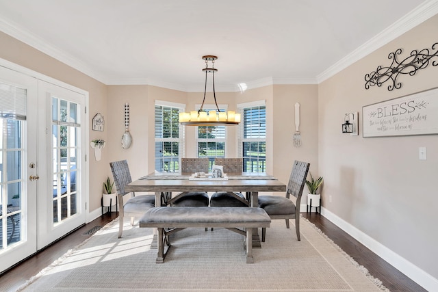 dining area featuring hardwood / wood-style flooring, crown molding, and french doors