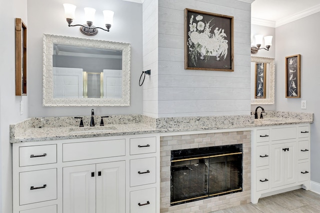 bathroom featuring a chandelier, vanity, and ornamental molding