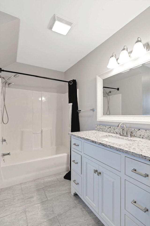 bathroom featuring washtub / shower combination and vanity