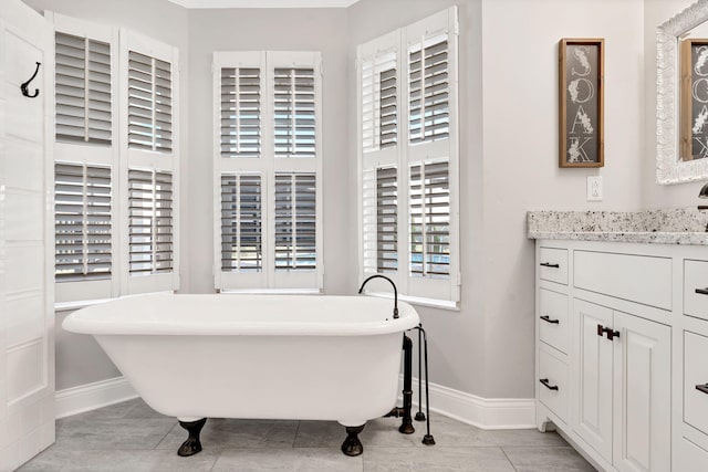 bathroom with tile patterned floors, vanity, and a bath