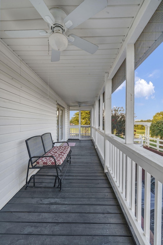 wooden deck featuring ceiling fan